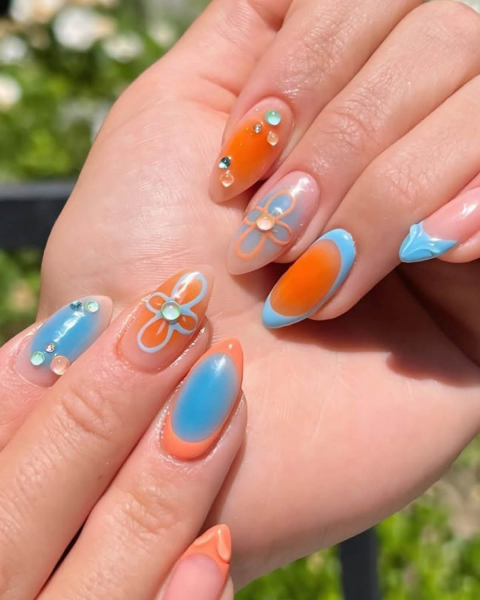 taylor swift tloas nails with daisy and aura nail art